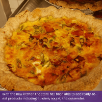Image of quiche. Text at the bottom of the image reads: With the new kitchen the store has been able to add ready-to-eat products including quiches, soups, and casseroles.
