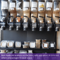 Image of prepackaged bulk foods underneath bulk bins inside PrairieLand Market. Text at the bottom of the image reads: Bulk foods are available at the store, with top-sellers in bins and others prepackaged to save space.