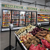 Fresh produce on display at Lane Co. Community Grocery during their grand opening in June 2026 with the coolers for grab and go and salads behind the produce