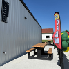 Tables outside of the newly opened Lane Co. Community Grocery Store as pictured with balloons to celebrate the store's grand opening