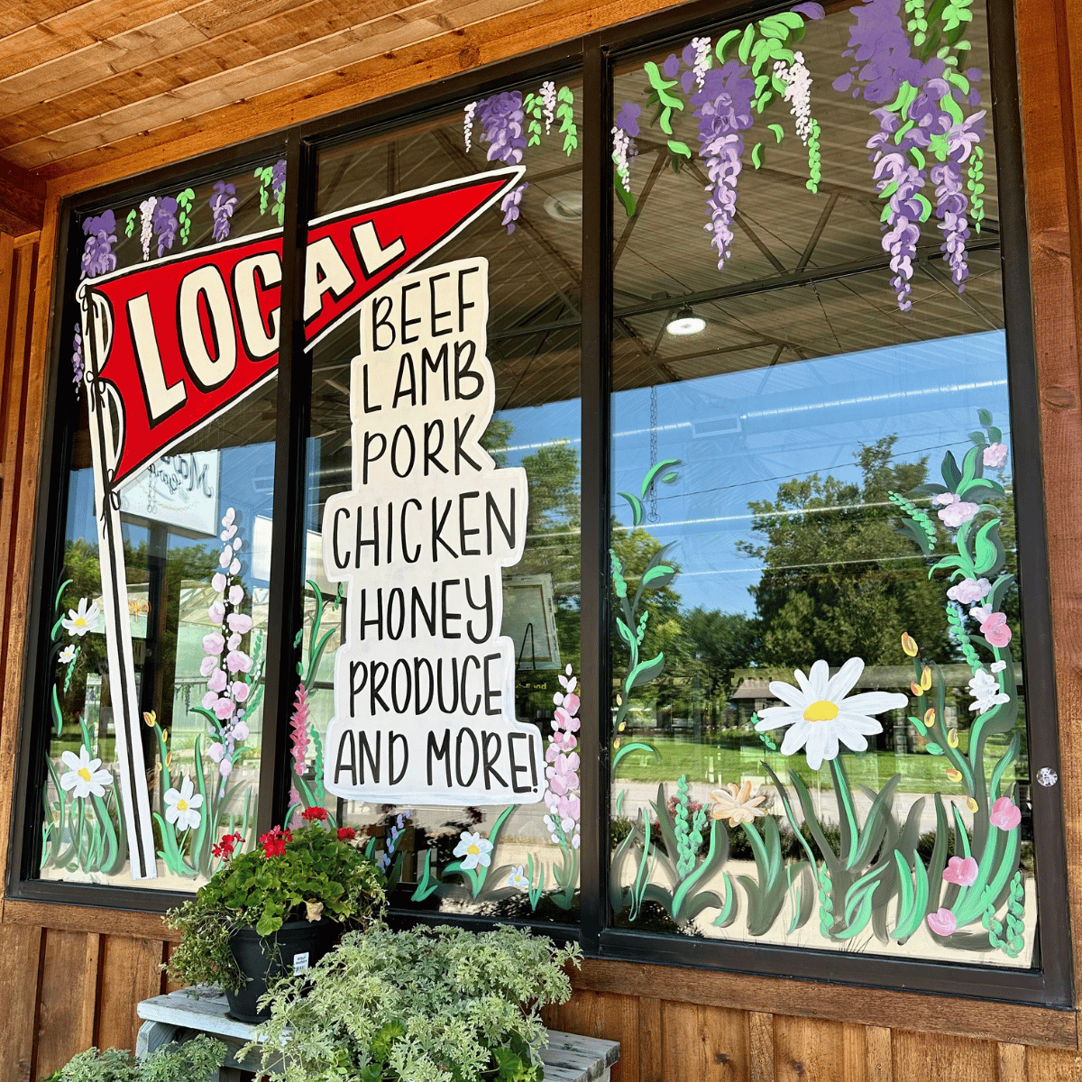 Window at Salt Creek Market adversiting local beef, lamb, pork, chicken, honey, produce, and more