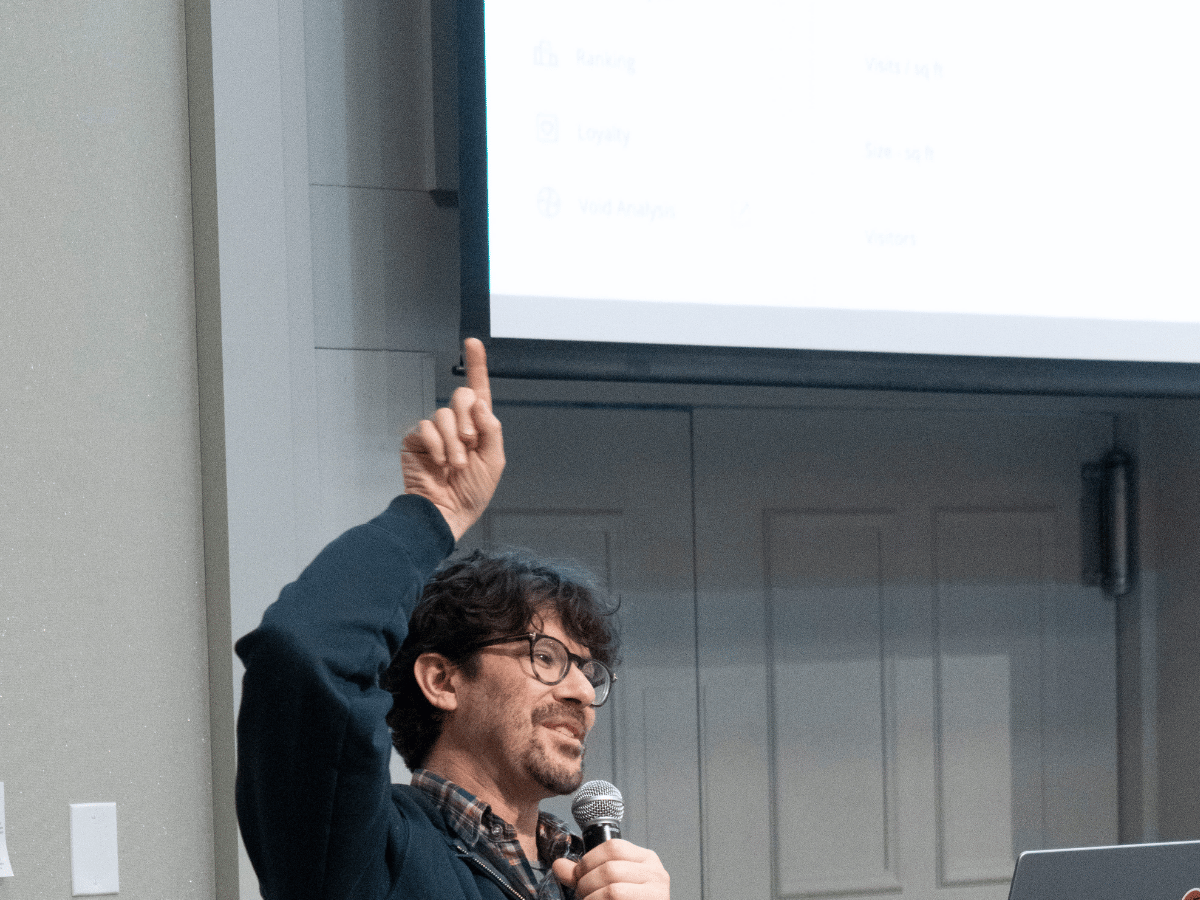 Presenter speaking at 2026 NRGS with slides behind